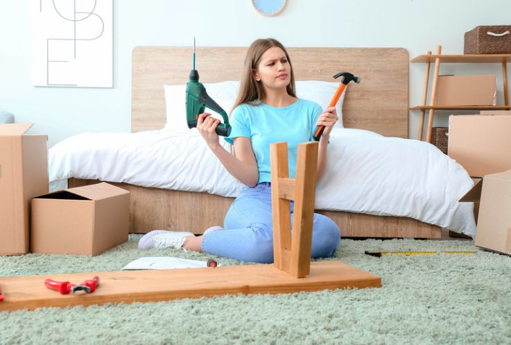 Woman deciding which tool to use for a DIY project