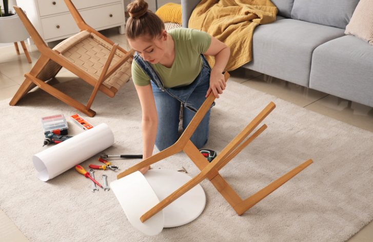 Woman assembling furniture at home